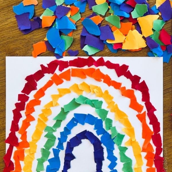 Are you looking for a fun rainy day activity? Bring the outdoors inside with this easy and cheap rainbow craft for kids. With just a few basic supplies including construction paper, glue and markers, your kids can make the prettiest torn paper rainbow craft ever! This boredom busting activity is simple to set up but will keep kids entertained as they fill in the colors of the rainbow. Make this a learning activity for preschoolers by asking what colors they are using for each line of their rainbows. What a great way for kids to learn their colors!