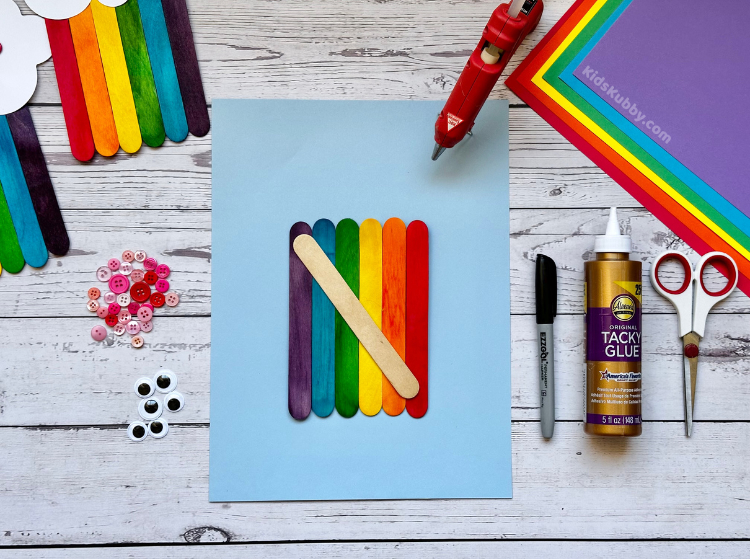 have you ever made rainbows with popsicle sticks? This is a fun and easy craft project for kids of all ages. Perfect for a preschool classroom. Learn the colors of the rainbow while making this fun smiling cloud rainbow project!