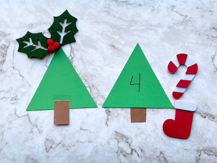 Cut tree triangles, add a brown rectangle for a stump. Write a number on the front and let your kids put dot stickers on the construction paper Christmas trees to match the number on the tree. Fun and educational DIY game for kids.