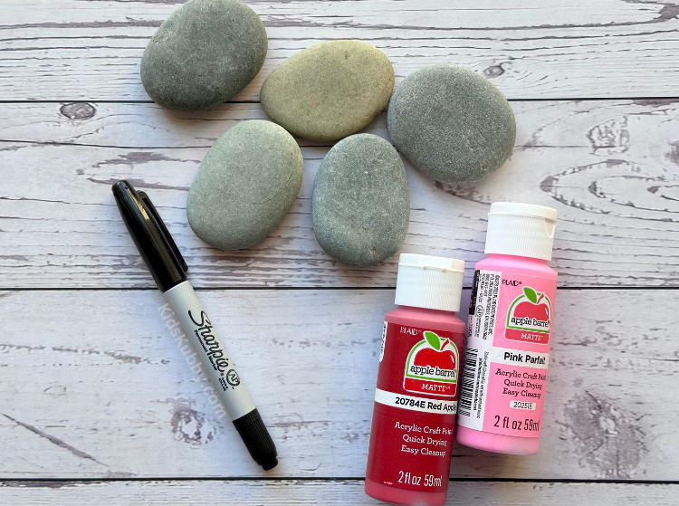 River rock, paint and a marker are all you need to make the cutest painted rocks ever. Valentine's Day fingerprint heart rocks are a fun craft for kids using cheap supplies. 