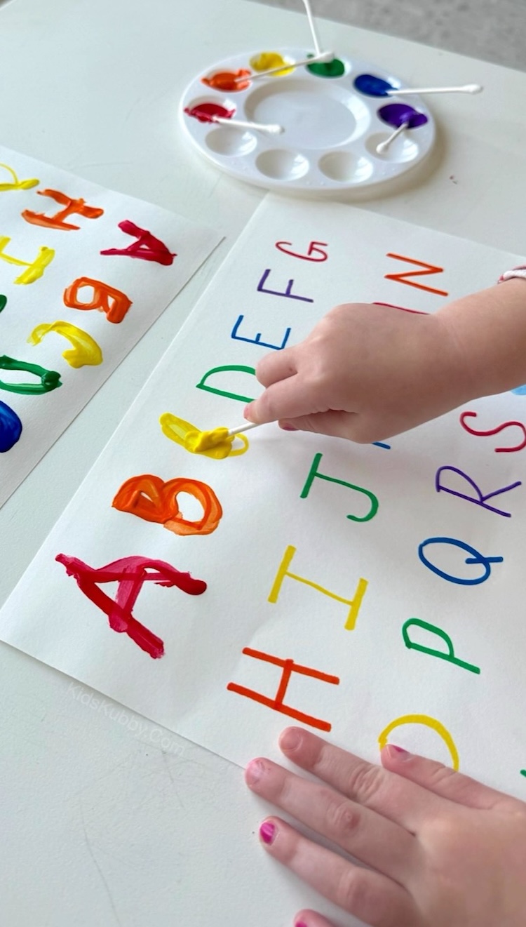 Tracing letters with q tips and paint! This exciting preschool activity is fun for a rainy day at home with your kids. Not only will they learn letter recognition, but they can work on their hand-eye coordination, fine motor skills, and art skills. 